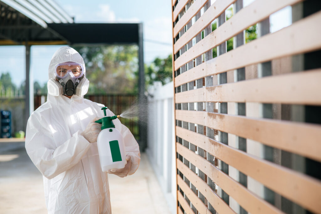 Technician in protective gear performing a treatment